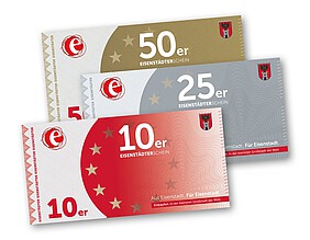 Ein roter, ein silberner und ein goldener Gutschein zu 10, 25 und 50 Euro.