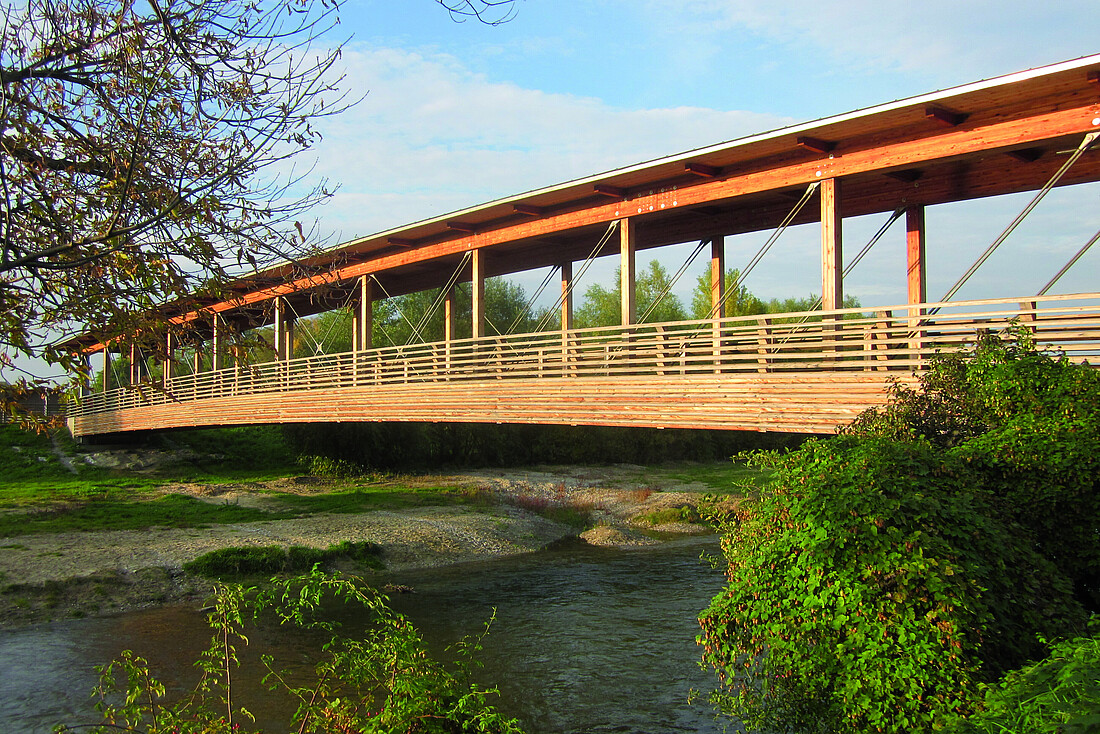 Hölzerne, überdachte Brücke über einen kleinen Fluss